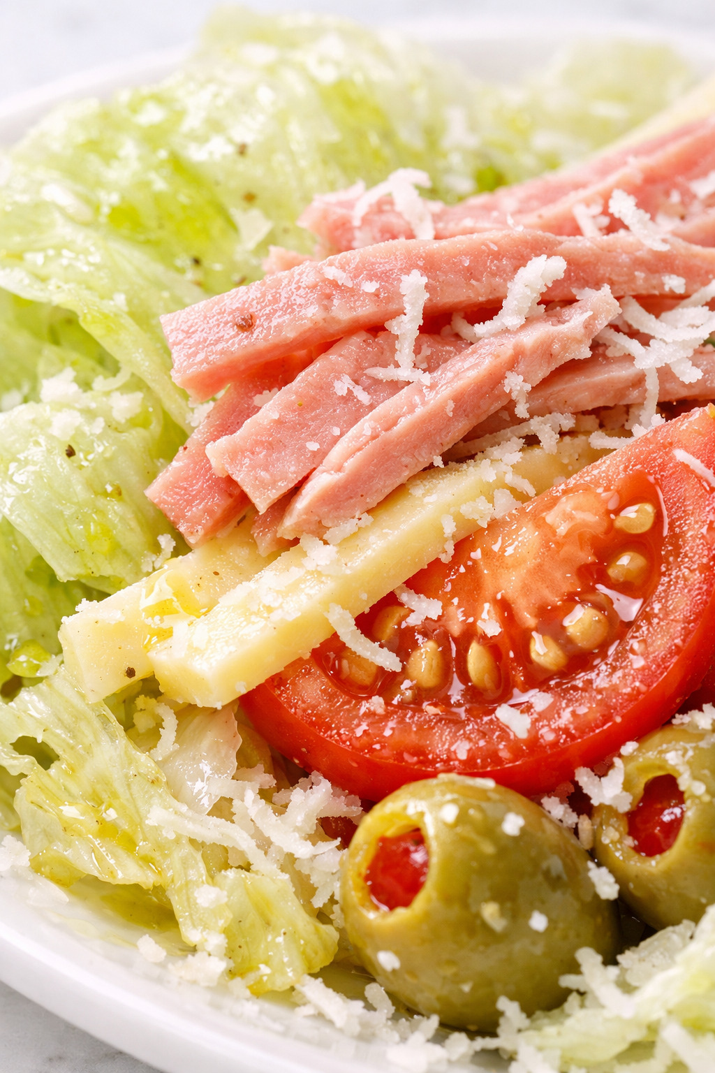 Closeup of 1905 salad showing julienned ham and Swiss cheese strips with Spanish olives