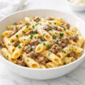 Creamy one pot beef pasta with garlic butter in a white bowl