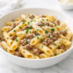 Creamy one pot beef pasta with garlic butter in a white bowl