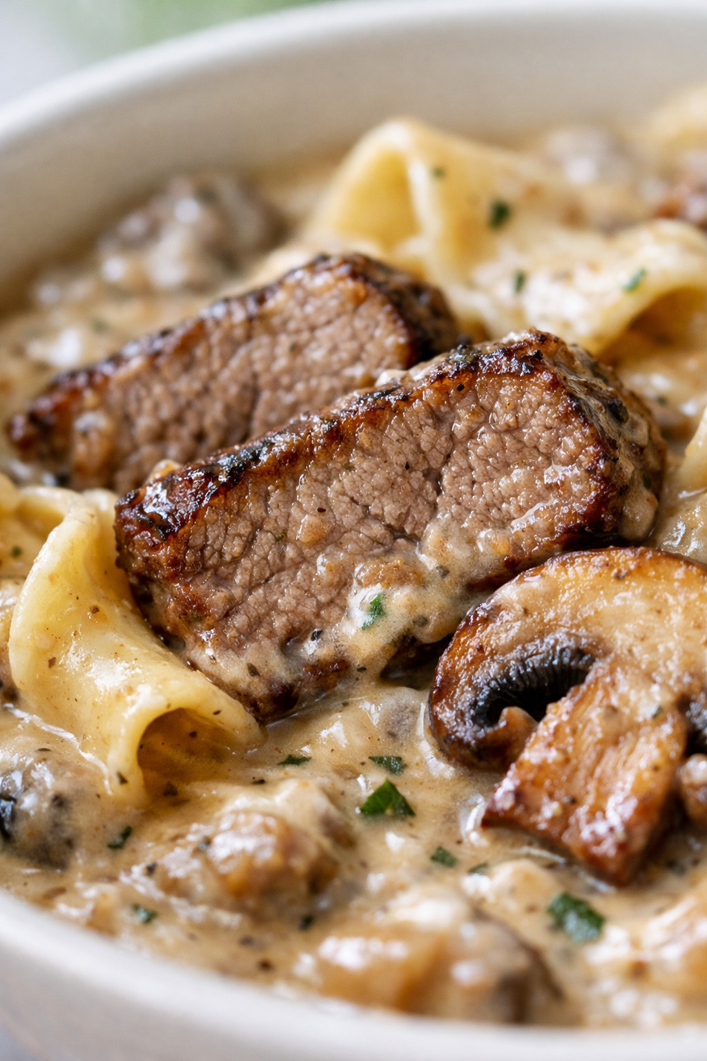 Closeup of tender beef strips in creamy mushroom sauce