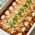Easy chicken enchiladas in a baking dish with melted cheese and red sauce