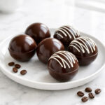 Chocolate coffee bombs with white chocolate drizzle