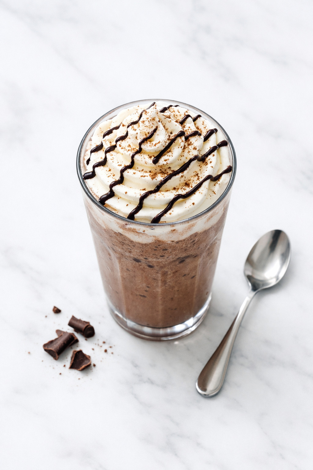 Overhead view of frozen hot chocolate with chocolate drizzle on whipped cream