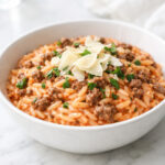Ground beef orzo with tomato cream sauce in a ceramic bowl