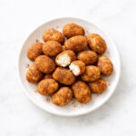 Irish Potato Candy dusted in cinnamon on white ceramic plate
