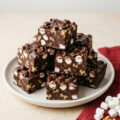 Rocky road fudge squares with marshmallows and almonds on slate board