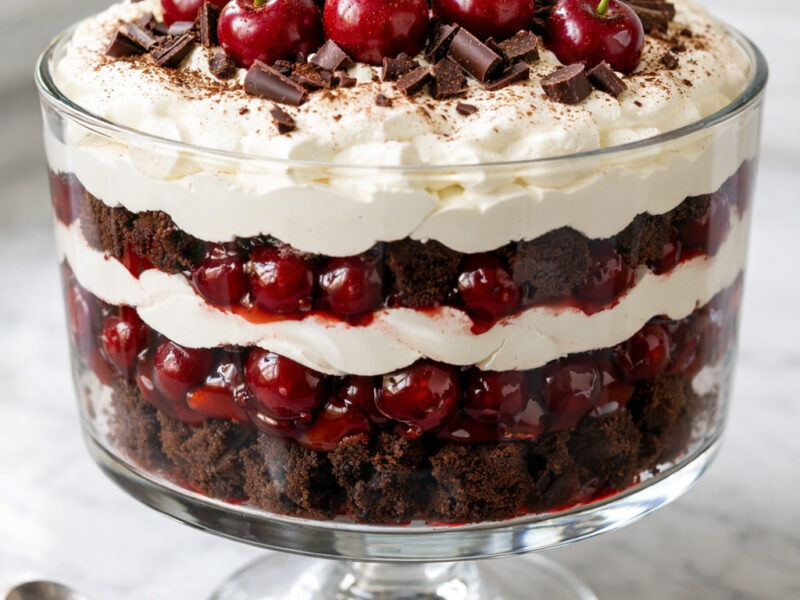 Black Forest trifle in clear glass bowl with chocolate, cherry and cream layers