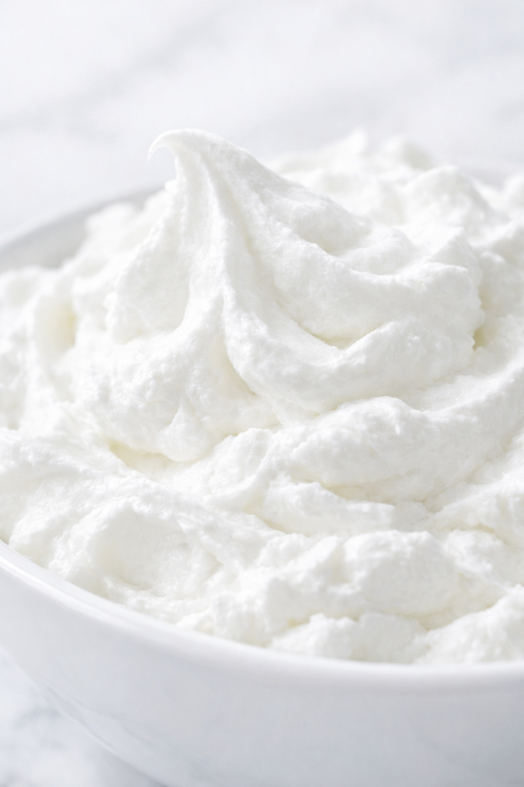 Whipped cream closeup showing fluffy texture