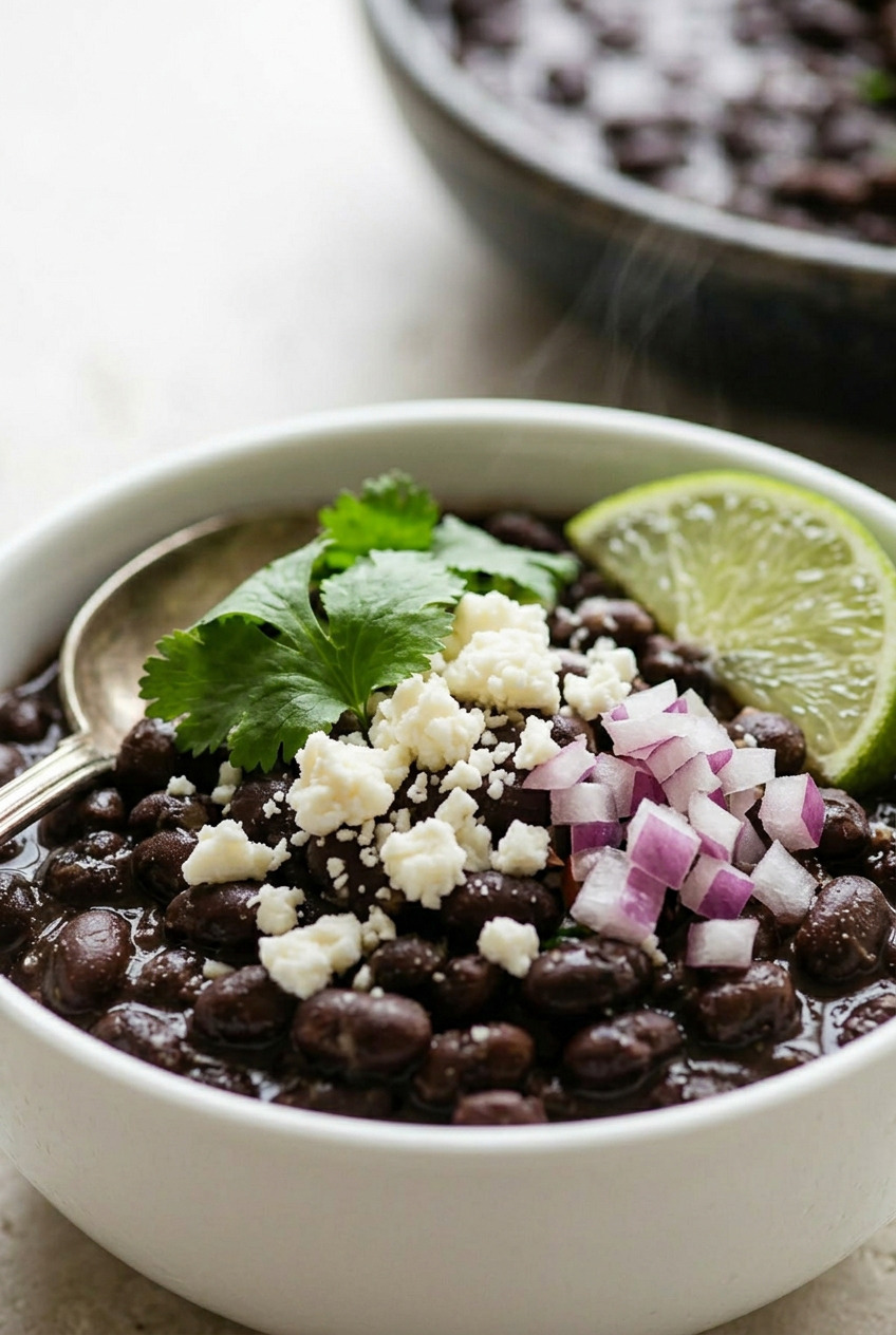 Mexican black beans served with queso fresco and lime